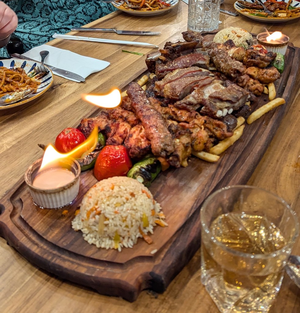 A board of absolutely fantastic looking barbequed ribs, skewers, veggies, rice and two little pots of FIAH! (fire, they are little pots on fire, I don't know why, please ask Jenn. I'm going to ask Jenn too! - Catherine