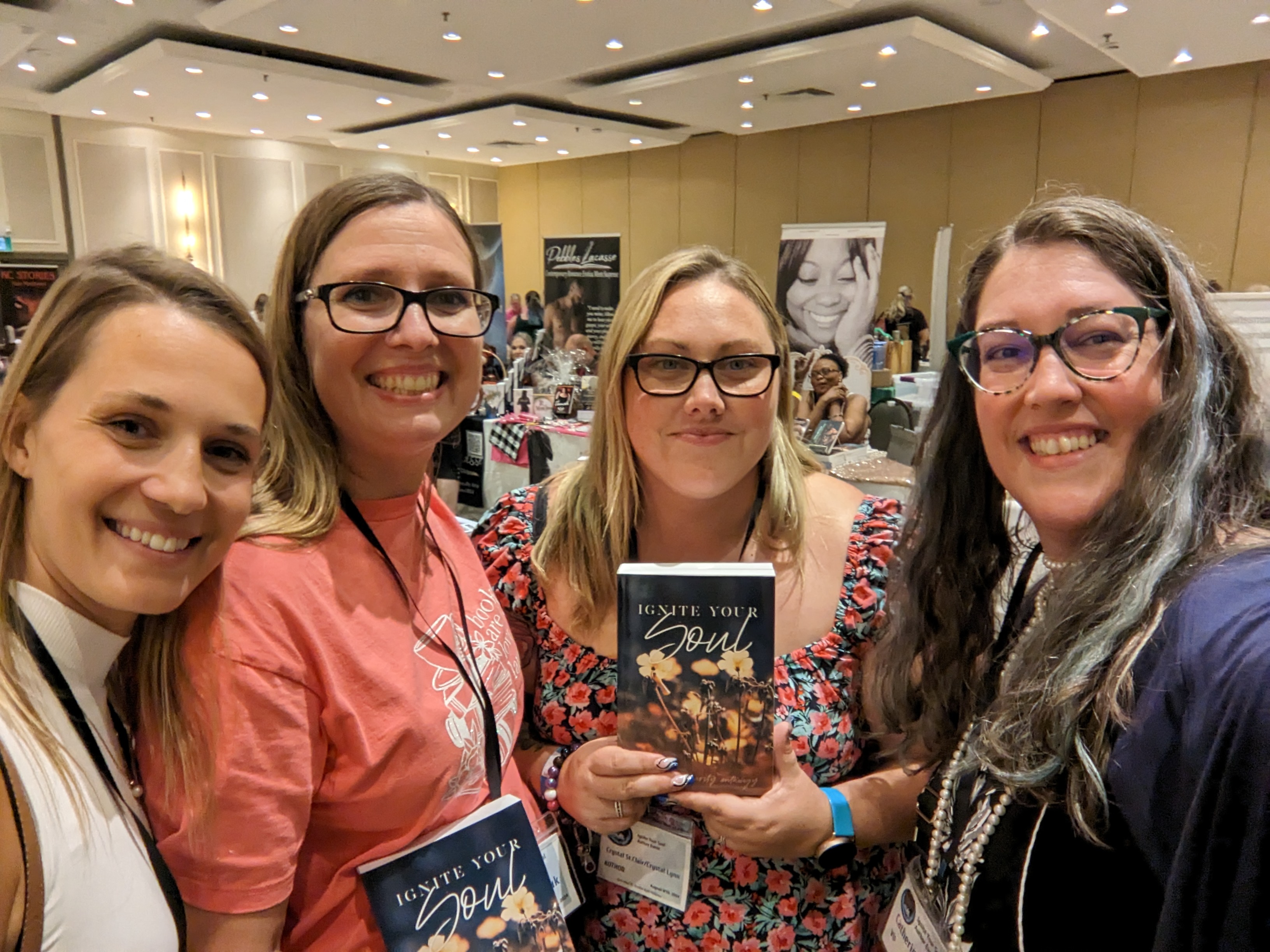 Left to right: Alexandra, her sister, Author Crystal. St. Clair holding the Ignited By Books anthology for 2024, and me again!