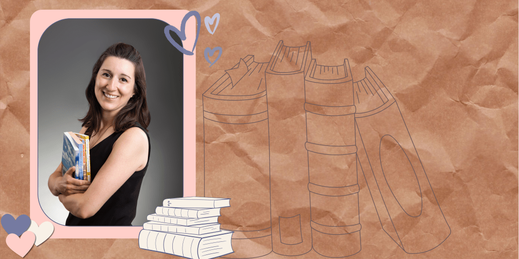 A white woman with brown hair holding books and looking very happy about it!