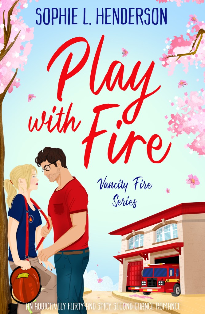 It’s an illustrated cover of a small, blonde woman with a neat ponytail, who is dressed in a firefighter uniform and leans against a pink cherry blossom tree. A tall, dark haired man, with a Clark Kent jawline and glasses, looks down at her, flirtily tugging on the red suspender of her uniform bunker pants. The scene is set on a street with a blue sky and a firehall behind them, a red fire truck ready to roll.
