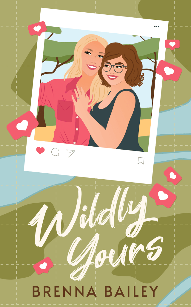 Two illustrated women hugging and smiling in an Instagram-style selfie surrounded by pink heart notifications. Below is the title “Wildly Yours” and the name “Brenna Bailey.” The background is an olive green suggestion of a map with blue rivers running through it. 